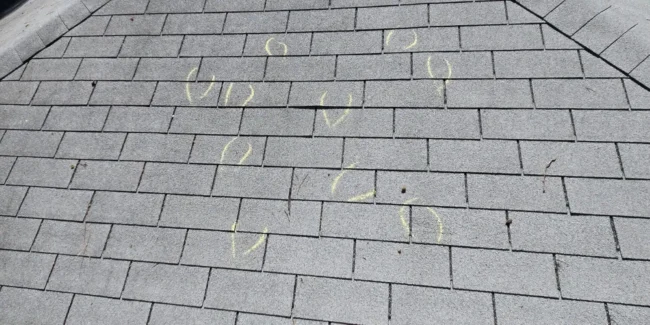 Shingled roof with chalk markings.